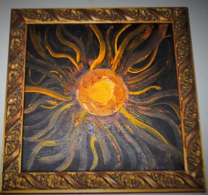 Image of a painting of an orange and yellow sun on a black background in a frame