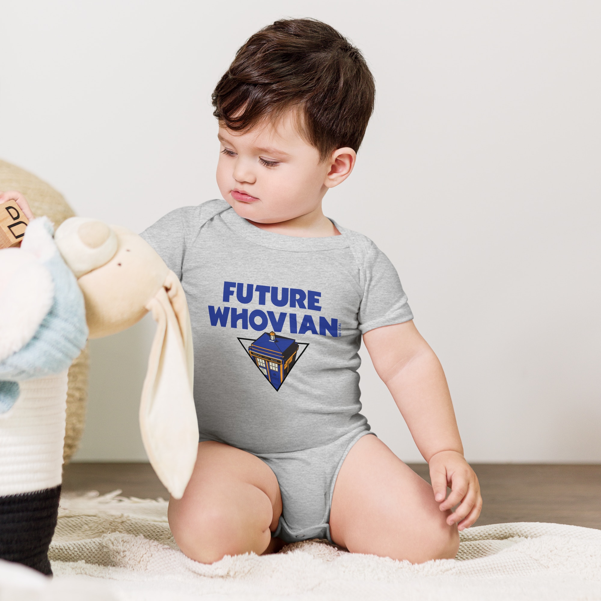 Baby wearing a a one sleeve top saying 'future whovian'