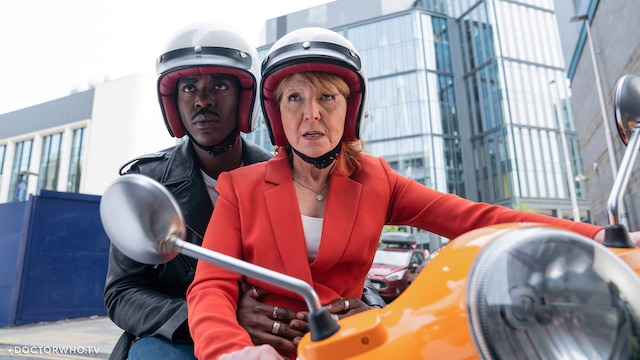 The Doctor and Mel on her orange Vespa in 'Empire of Death'