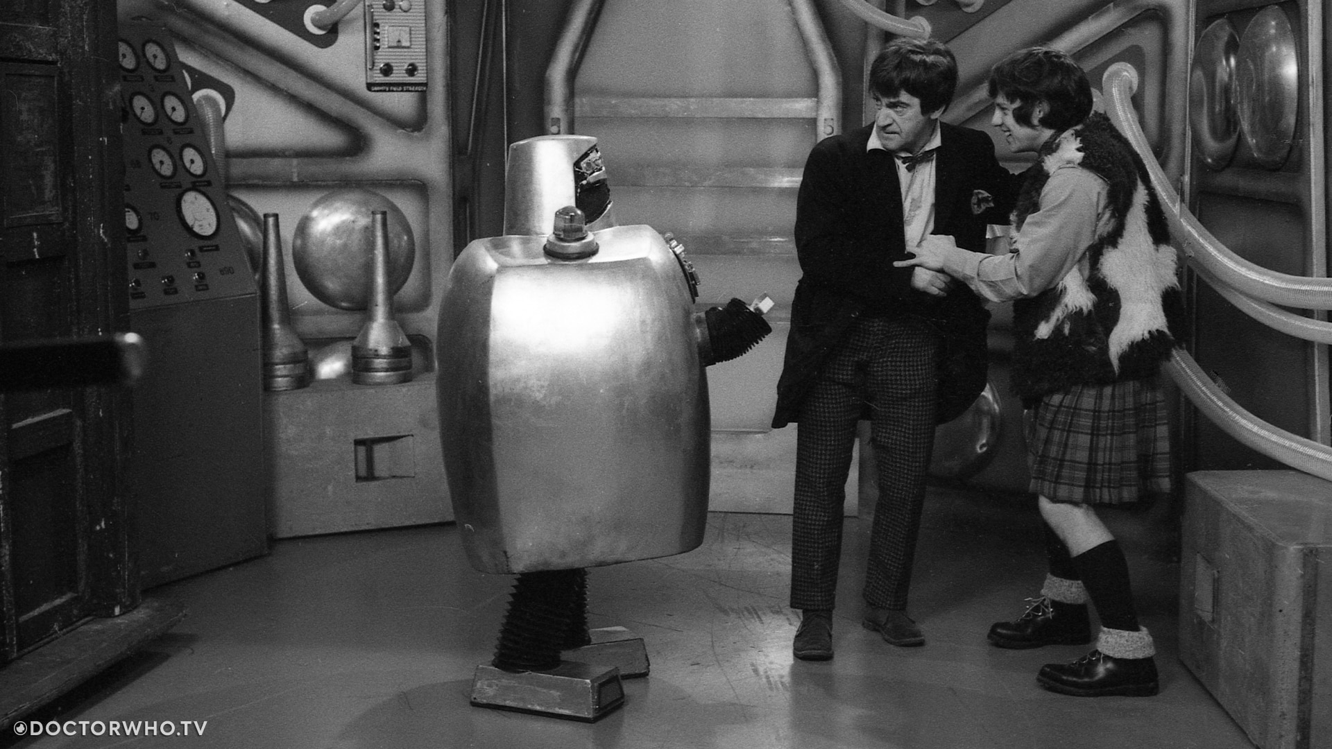 The Doctor and Jamie retreat from a threatening robot in partially missing serial 'The Wheel in Space'.
