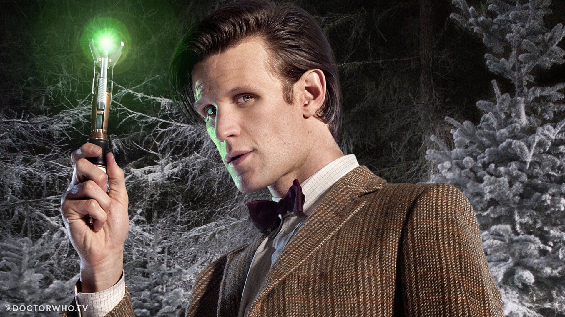 The Eleventh Doctor shows off the green emitter on his sonic screwdriver.
