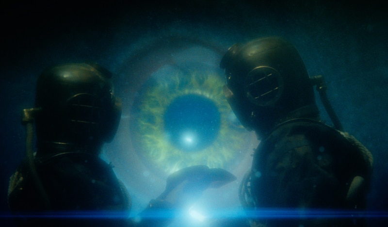the doctor underwater facing a huge eye 