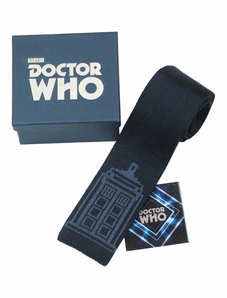 Image of blue knitted tie with an image of the TARDIS on it, next to a blue presentation box with the Doctor Who logo on it