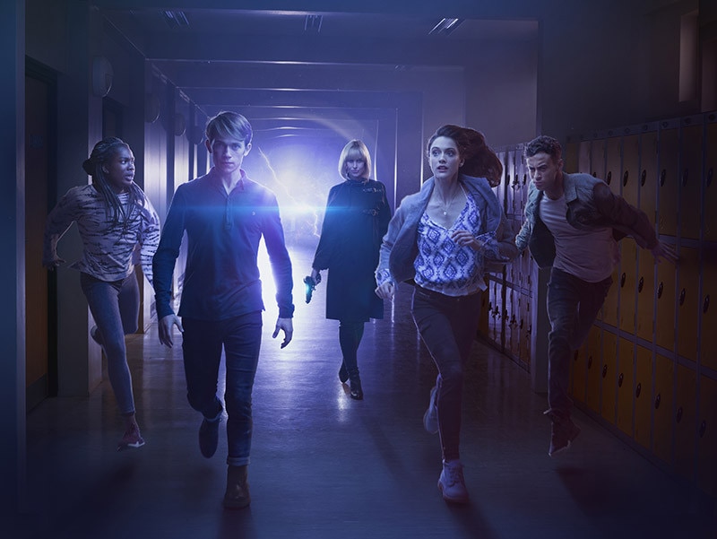 Image from of characters from Class running down school corridor with lightning bolt behind them