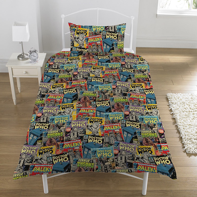 Image of bed with Doctor Who bedsheets with the TARDIS and Doctor Who monsters on