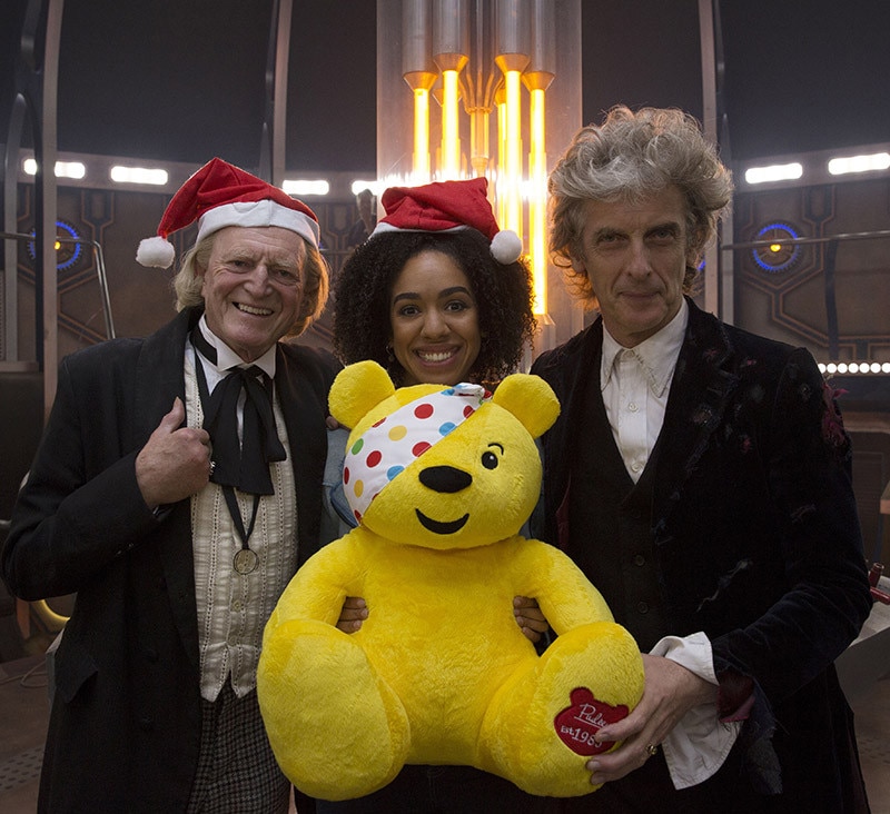 Image of David Bradley, Pearl Mackie and Peter Capaldi holding Pudsey in the TARDIS