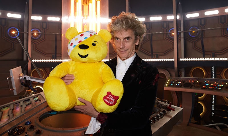 Image of Peter Capaldi holding Pudsey bear in the TARDIS