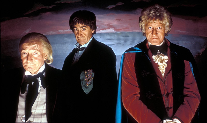 Image of The First Doctor stood next to The Second Doctor and The Third Doctor