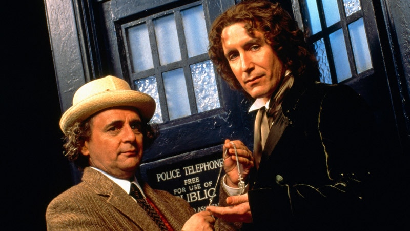 Image of Sylvester McCoy and Paul McGann stood outside the TARDIS