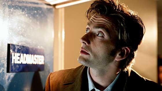 The Tenth Doctor peers out of a door in School Reunion